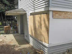 Photo by Emran Nuru, age 16 "Some windows at Yesler Terrace are now covered with boards. The family who once lived here had sun shining into their home in the afternoons. The fences around Yesler Terrace are also old and bent with age."