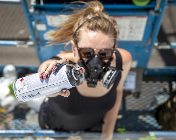 Artist Ola Volo at work on a mural for the SODO Track. Photo by @wiseknave.