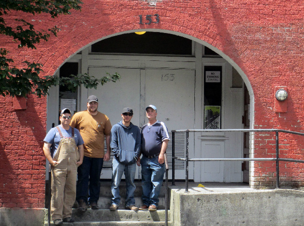 Vets Restore participants Scott Carlson, Brandon Reddell, Sergio Cruz and David Pelletier, on the steps of the historic Washington Hall, Seattle. © 2013 Maura Schlagel