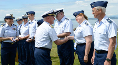 Will Winter (right) prepares to receive a centennial medal from Rear Admiral Keith Taylor at the June 1, 2013, centennial ceremony at Alki Lighthouse. (U.S. Coast Guard photo by Petty Officer 3rd Class Jordan Akiyama.)