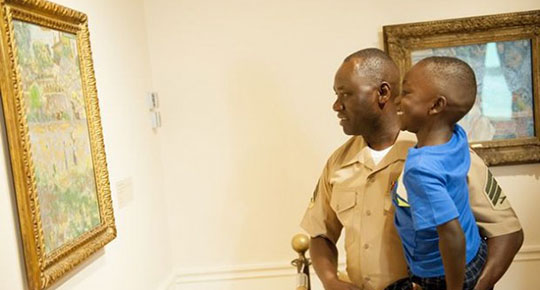 Marine Sgt. Jimmy Ochan and his son William enjoy their visit to the Phillips Collection at the 2015 launch event for Blue Star Museums.