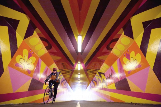 A cyclist zips through Ebb and Flow, under 96th Avenue NE in Bothell. Photo: Ken Lambert, The Seattle Times.