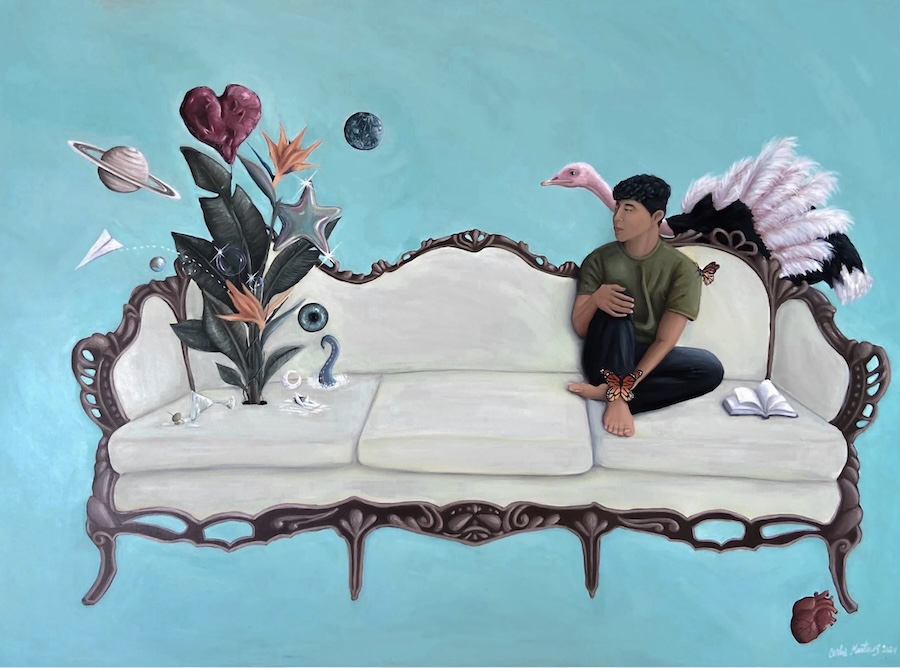 A person sits cross-legged on a vintage-style sofa, surrounded by surreal elements like planets, a flamingo, floating plants, and a paper airplane, against a turquoise background. An open book lies beside them.