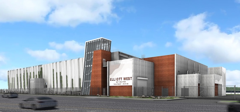 A modern, multi-story correctional facility with concrete and red brick walls, large windows, fencing, and a sign reading Elliott West, New York City, Replacement Jail, Facility Design. Cars drive by on the street.