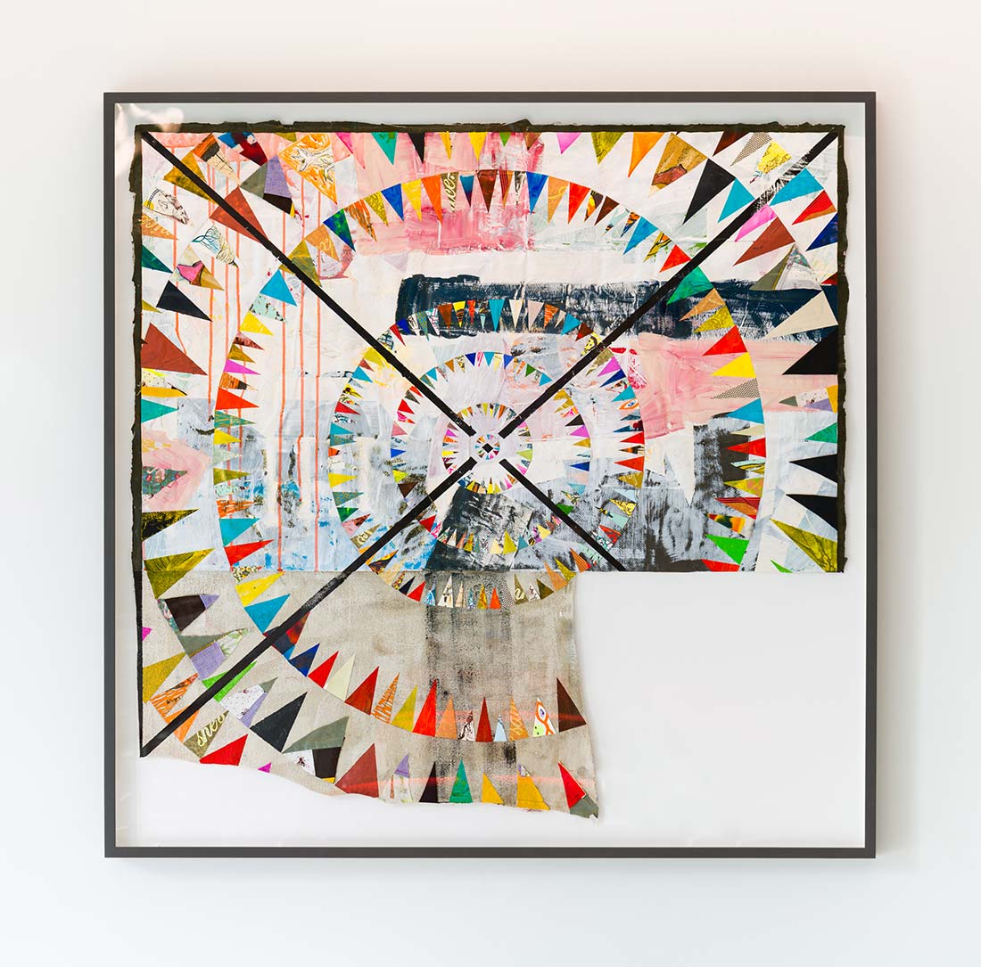 Framed abstract artwork featuring colorful, triangular shapes arranged in concentric circles with a patchwork of textures, paint splashes, and layered materials on an off-white background.