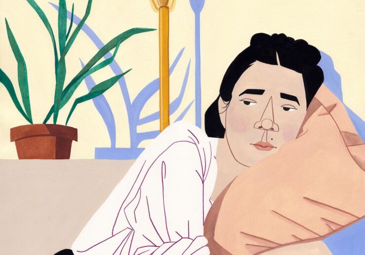 An illustration of a person with dark hair resting their head on a peach pillow, looking thoughtful. Theres a potted plant and a lamp in the background with pastel blue and yellow tones.